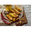 Oven-baked potatoes on a wooden table in rustic style