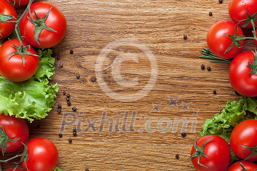 red tomatoes with green salad on wood