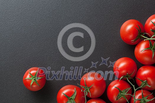red tomatoes on black. top view