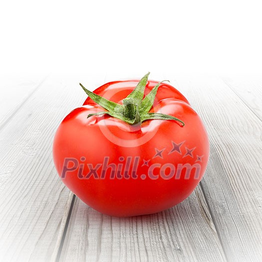 red tomato isolated on white wood
