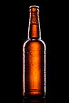 Beer bottle with water drops isolated on black