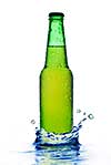 Green beer bottle with water drops and splash isolated on white