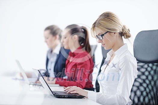 Pretty young business woman group with headphones smiling at you against white background Pretty young business woman group with headphones smiling at you against white background