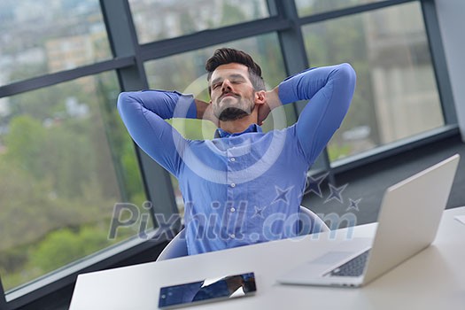 happy young business man work in modern office on computer happy young business man work in modern office on computer
