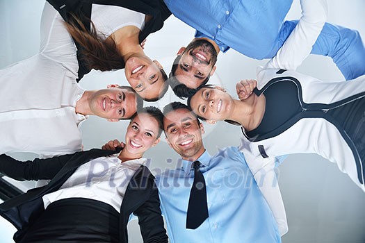 business people group joining hands and representing concept of friendship and teamwork, low angle view business people group joining hands and representing concept of friendship and teamwork, low angle view