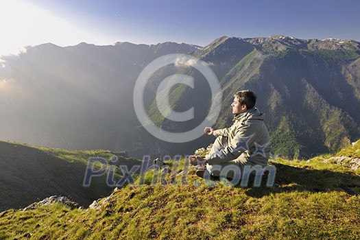 healthy young man practice youga in height mountain at early morning and sunrise healthy young man practice youga in height mountain at early morning and sunrise