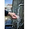 clear fresh mountain water falling on hands outdoor in nature