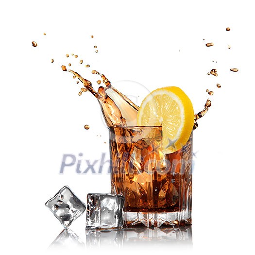 splash of cola in glass with lemon and ice isolated on white