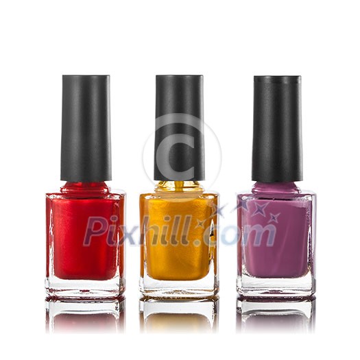 different colors of nail polish in bottles isolated on white different colors of nail polish in bottles isolated on white