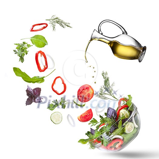 Falling vegetables for salad and oil isolated on white Falling vegetables for salad and oil isolated on white