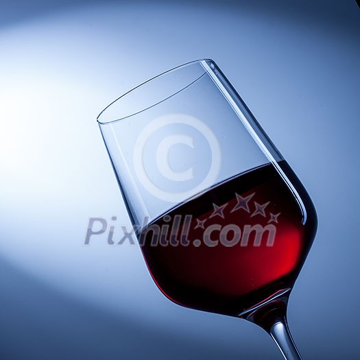 red wine in glass on blue