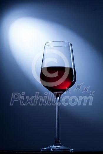 red wine in glass on blue