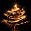 Fir tree of burning christmas sparkler on black background. Bengal fire
