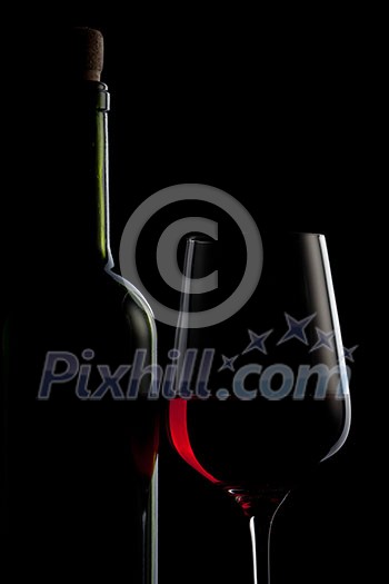 red wine in glass and bottle isolated on black red wine in glass and bottle isolated on black