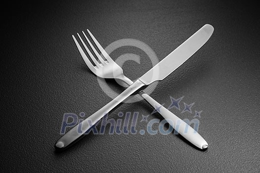 crossed knife and fork on black crossed knife and fork on black