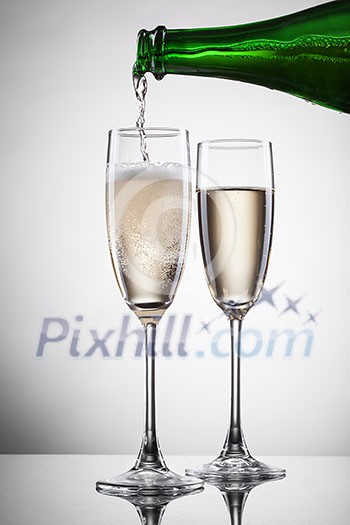 Champagne pouring into glass isolated on white Champagne pouring into glass isolated on white