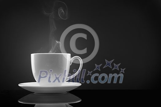 white cup with hot liquid and steam on black