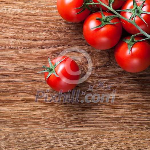 red tomatoes with green salad on wooden background red tomatoes with green salad on wooden background