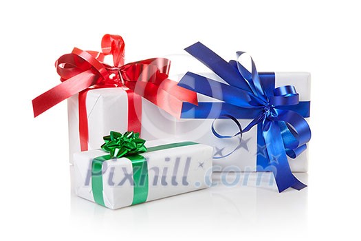 Holiday gifts with color ribbons isolated on white