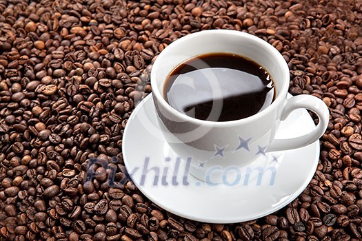 white cup with coffee beans white cup with coffee beans