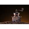 Retro manual coffee mill on roasted coffee beans