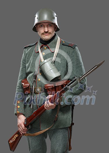 German infantryman during the first world war. Soldier with gun. Isolated on gray.