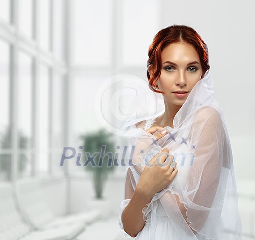 Portrait of Beautiful Young Fashion Bride in interior.