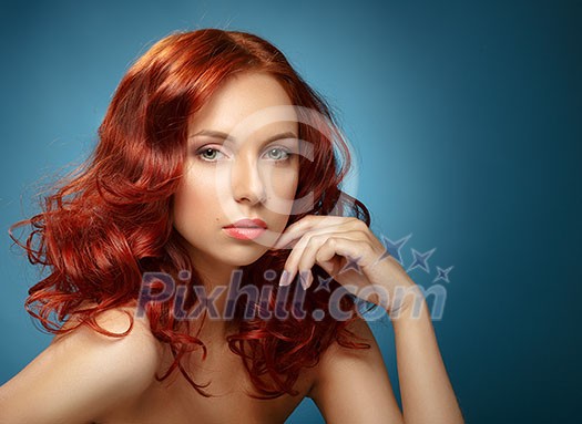 Long Curly Red Hair. Fashion Woman Portrait. Beauty Model Girl with Luxurious Hair and Make up. Hairstyle. Wavy Hair Extensions Concept. Classic Makeup.