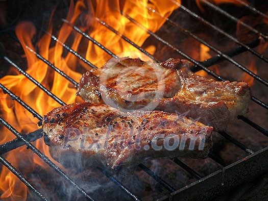 A top sirloin steak flame broiled on a barbecue, shallow depth of field