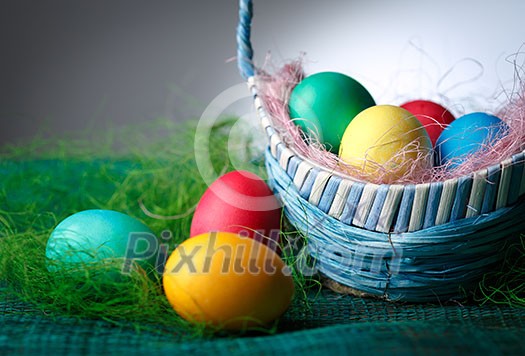 Easter eggs in the basket. Dark background. Easter eggs in the basket. Dark background.