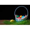 Easter eggs in the basket. Dark background.