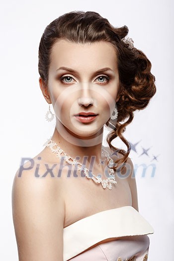 Bride. Portrait of a beautiful woman in a pink wedding dress. Updo.