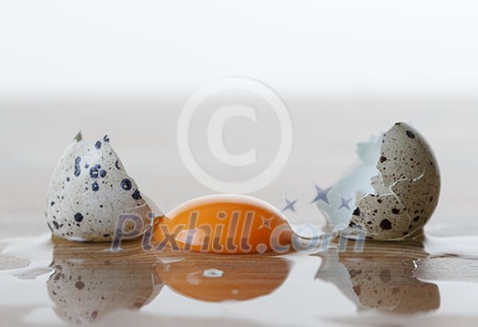 Quail egg broken on the table. Quail egg broken on the table.