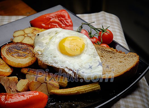 Fried eggs on bread. Plate of grilled vegetables