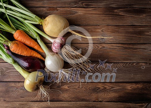 Fresh vegetables on a wooden table. Rustic style. Vegetarianism. Organic food. Space for text.