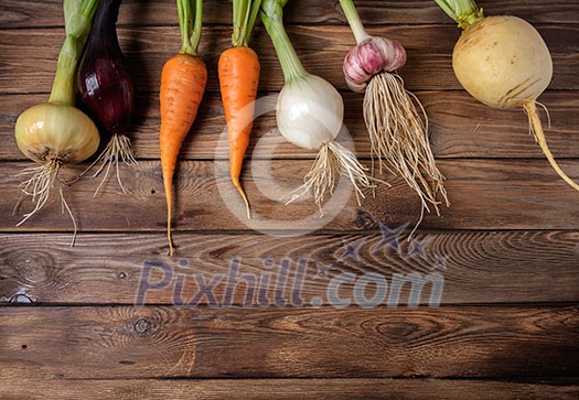 Fresh vegetables on a wooden table. Rustic style. Vegetarianism. Organic food. Space for text.