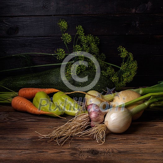 Fresh vegetables on a wooden table. Rustic style. Vegetarianism. Organic food. Space for text.