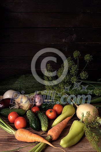 Fresh vegetables on a wooden table. Rustic style. Vegetarianism. Organic food. Space for text.