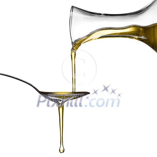 Pouring oil on spoon isolated on white Pouring oil on spoon isolated on white