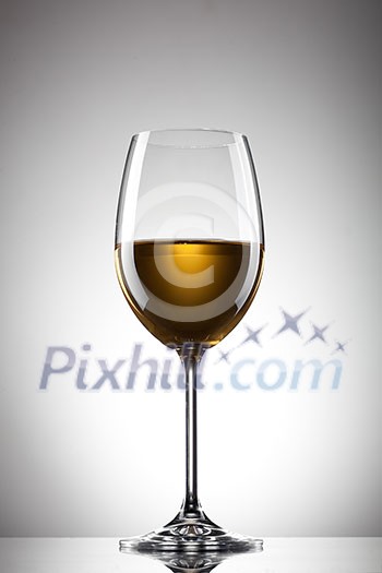 White wine in the glass on white White wine in the glass on white