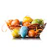 color easter eggs in basket isolated on white