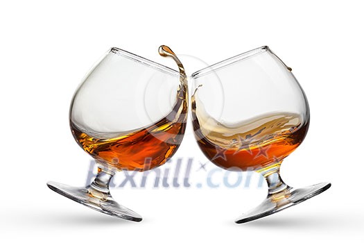 Splash of cognac in two glasses isolated on white background Splash of cognac in two glasses isolated on white background