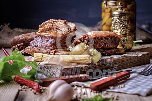 Baked spare ribs with herbs and spices. Wooden background. Rustic style.