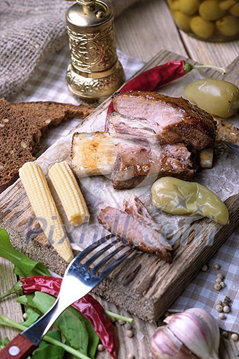 Baked spare ribs with herbs and spices. Wooden background. Rustic style. Baked spare ribs with herbs and spices. Wooden background. Rustic style.