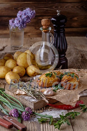 Sliced baked potatoes over wooden background. Rustic style. Selective focus. Sliced baked potatoes over wooden background. Rustic style. Selective focus.