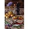 Sliced baked potatoes over wooden background. Rustic style. Selective focus.