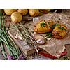 Sliced baked potatoes over wooden background. Rustic style.