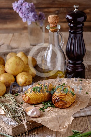 Sliced baked potatoes over wooden background. Rustic style. Sliced baked potatoes over wooden background. Rustic style.