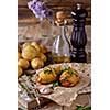 Sliced baked potatoes over wooden background. Rustic style.