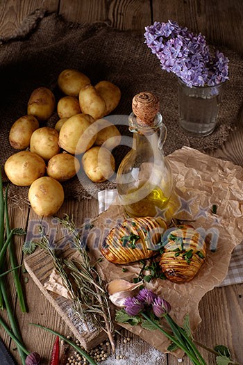 Sliced baked potatoes over wooden background. Rustic style. Sliced baked potatoes over wooden background. Rustic style.